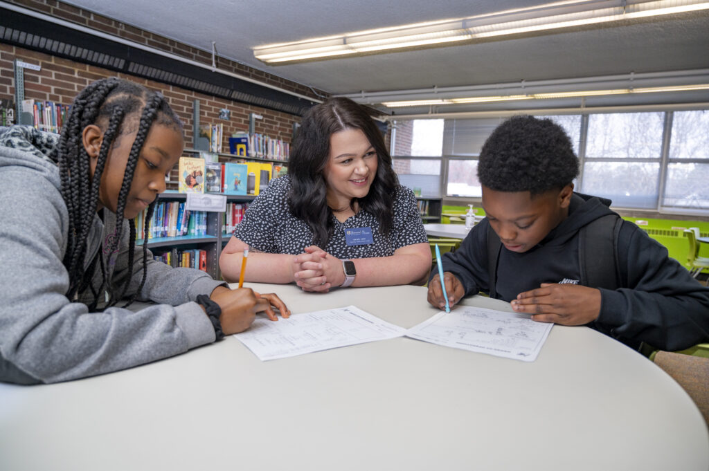 IPIE Graduate student tutoring two K-12 students.