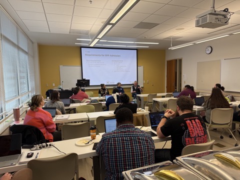 Group of educators sit in classroom to learn about the licensure process from presenter.