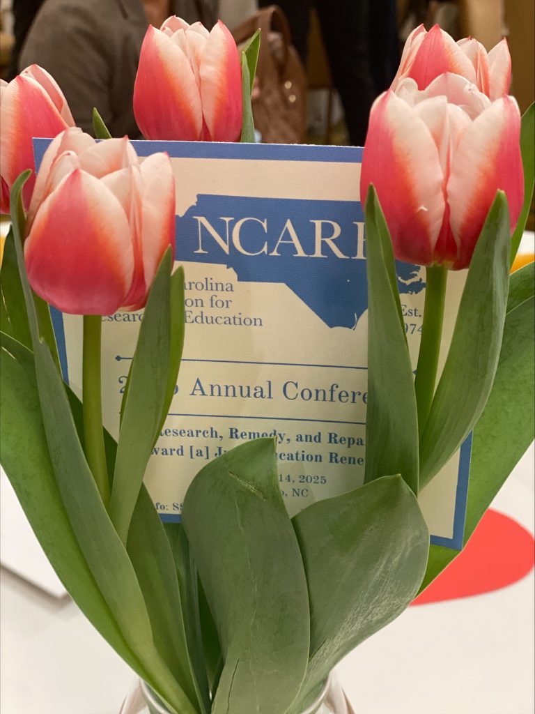NCARE Conference card in tulips.